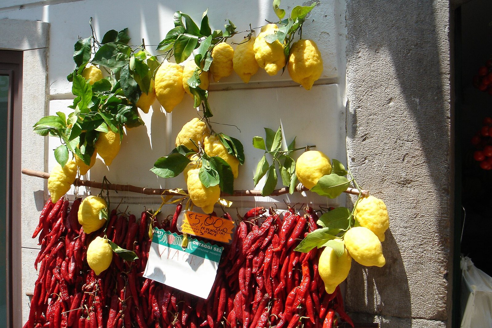 Limoni e peperoncini appesi a un muro in Costiera Amalfitana